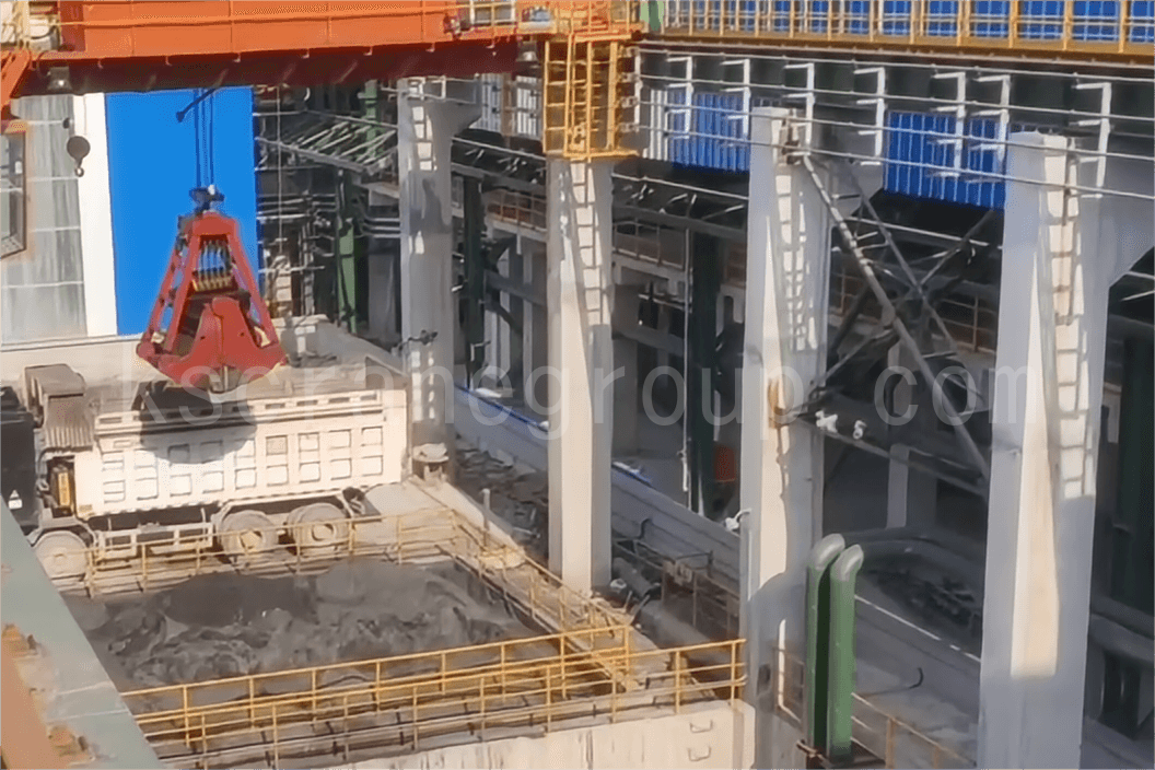 Overhead crane with grab bucket for slag handling and loading onto trucks